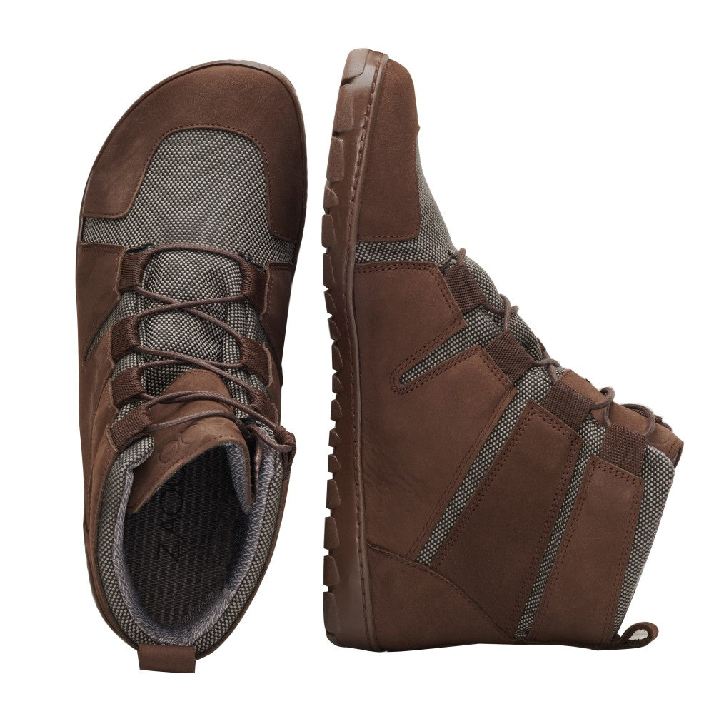 Wir präsentieren den DAQOTA Waterproof Brown von ZAQQ: ein Paar Wanderstiefel aus strukturiertem Stoff und Lederakzenten. Ein Stiefel steht aufrecht, während der andere auf der Seite liegt, wodurch die Outdoorsohle hervorgehoben wird. Diese Schnürverschlüsse sind mit einer robusten, wasserdichten Konstruktion ausgestattet und eignen sich daher perfekt für Outdoor-Aktivitäten.